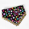 a colorful handmade polka dot pet bandana with tassel lace trim on a clean white studio background.
